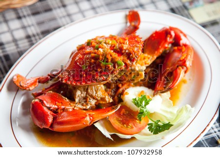 cooked crabs with spicy sauce on white plate (selective Focus)