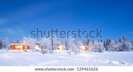 Winter landscape with cabin hut at night in Kiruna Sweden at Night with star trail