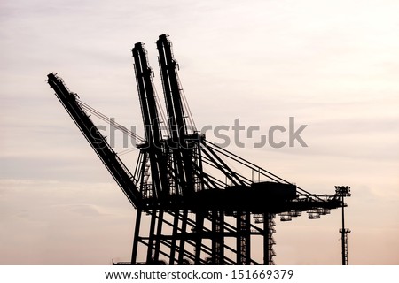silhouette of Cargo crane at Terminal port during sunset