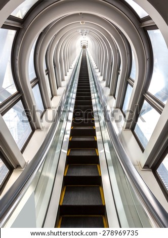 perspective escalators stairway inside contemporary blue glass business centre, concept of successful career elevation