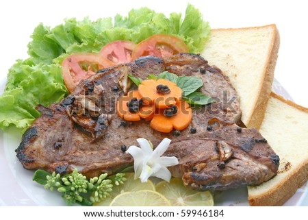 T Bone Pepper Steak with vegetable and bread, closeup