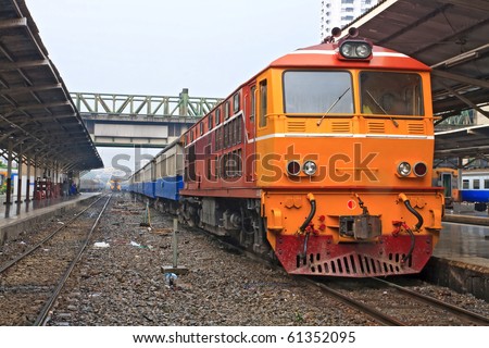 Closeup of Red orange train, Diesel locomotive, on Bangkok railway station platform Thailand