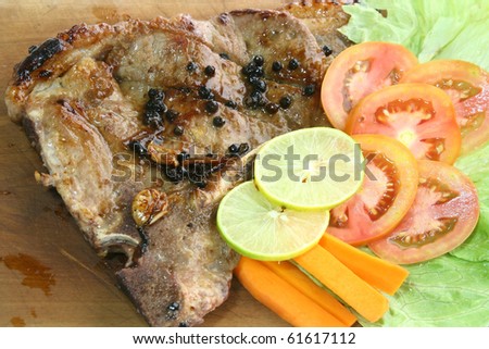 T Bone Pepper Steak with vegetable on Wooden board