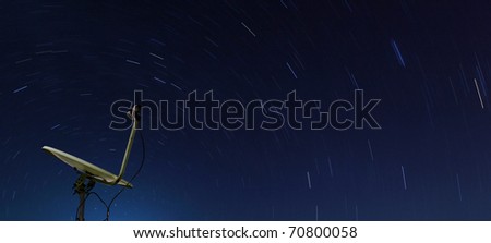 Conceptual of yellow satellite over spiral star at night