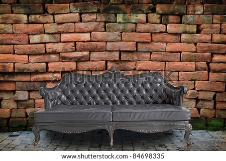 black genuine leather classical style sofa in vintage room