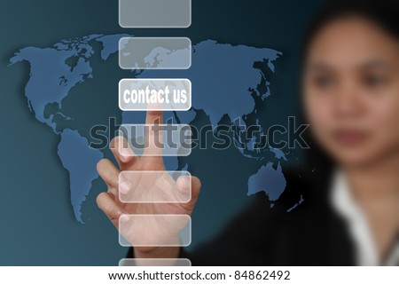 female hand touch on contact us button with world map background