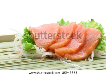 Fresh salmon sashimi salad on bamboo dish
