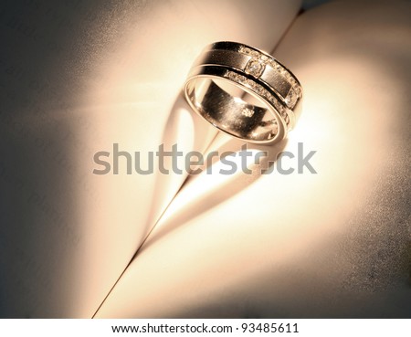 Wedding Luxury Diamond ring casting a heart on Book Using for \