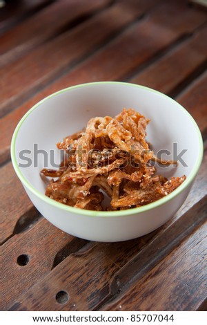 Thailand food : mushroom fry with sesame in white round bowl on wood background pattern