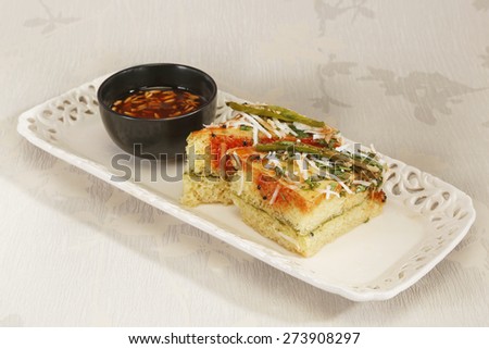 Indian Food Dhokla topped with sesame seeds and green chilly