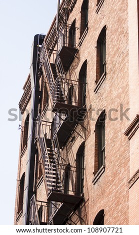 Black iron fire escape on an old red brick building