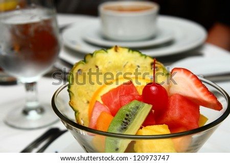 A fresh and tasty appetizer of cut fruit on a formal dinner table
