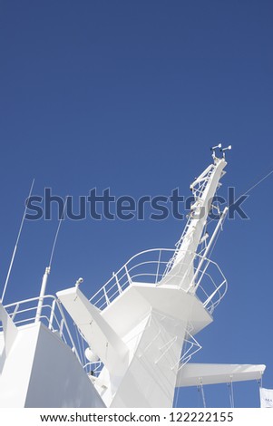 White crow\'s nest at the top of a luxury cruise ship under a clear blue sky