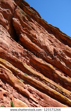 Centuries of erosion cutting through red rock hills in Colorado