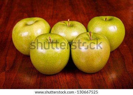 Green granny smith apples on a wood table