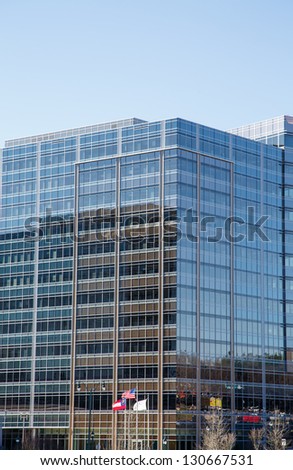 Modern Glass Office Building with American and Georgian flag out front