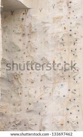 A climbing wall with a bell at the top corner to signal success