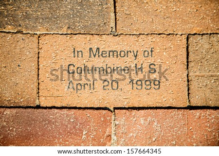 A bick in a sidewalk in Denver in memory of the Columbine High School shooting in Arip of 1999