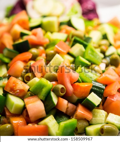Fresh salad on a salad bar of cucumbers, tomatoes and olives