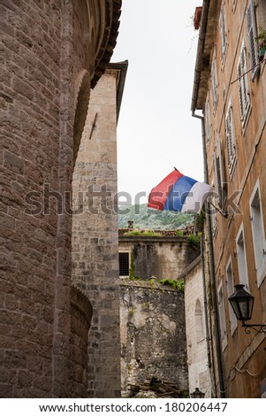 Flag of Serbia flying in Kotor, Montenegro alley