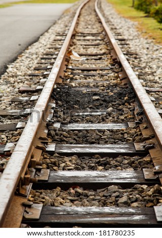 Old narrow gauge railroad tracks into distance