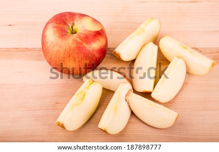 Apples cut on a wood cutting board