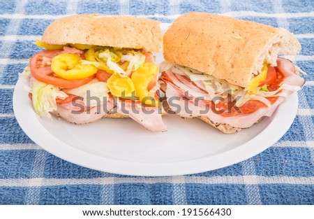A fresh, italian sub sandwich on a white plate