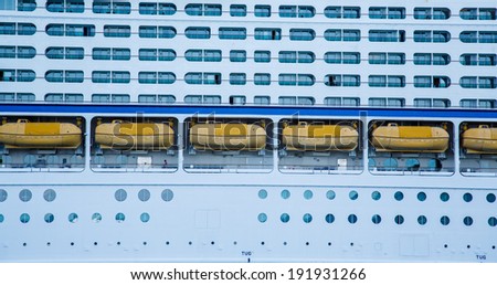 Huge, white, luxury cruise ship anchored in blue water
