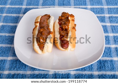 Two Chili Dogs on a white plate