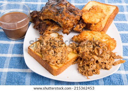 Barbecue Plate with chopped pork sandwich, rack of ribs and chicken fingers