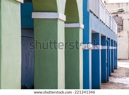Blue and Green Plaster columns with white trim into distance