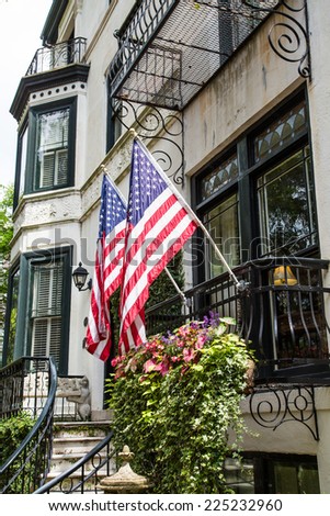 Two American flags on railing of a classic old home in Savannah, Georgia