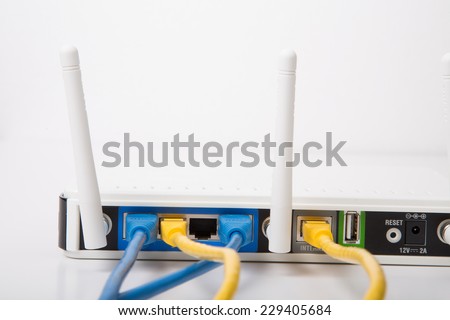 Modern wireless router with blue and yellow ethernet cables