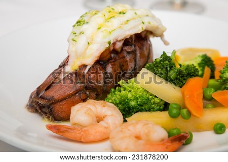 A seafood dinner of lobster tail, shrimp and vegetables