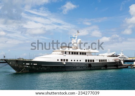 Huge old black and white yacht in a calm blue harbor