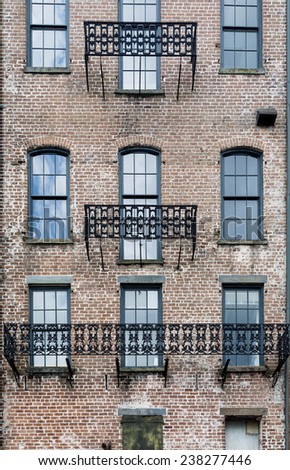 Old brick building with black iron trim outside windows