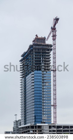 New office tower construction with red crane