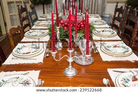 An elegant dining room table decorated for a Christmas dinner