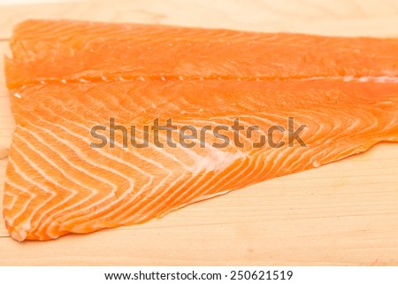 Fresh, raw piece of atlantic salmon on a wood cutting board