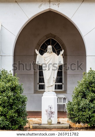 Stone statue of Jesus in the courtyard of a church