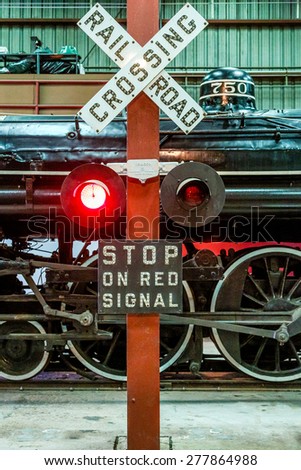 A classic Railroad Crossing sign and Old Locomotive