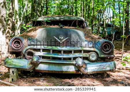 DETROIT, MICHIGAN - May 11, 2015: Wreck of a vintage Cadillac. The logo has changed, but this original was based on coat of arms for Le Sieur Antoine De La Mothe Cadillac, the man who founded Detroit