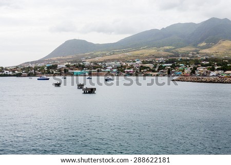 Coast of St Kitts with small boats and concrete mooring platforms