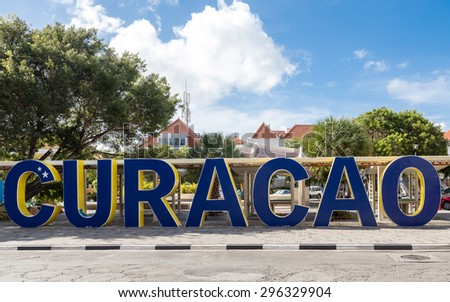 Huge blue sign spelling out Curacao in city park