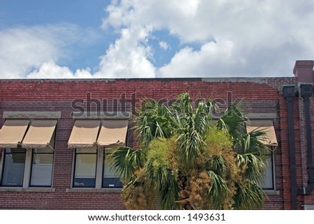 Old brick building with awnings on windows