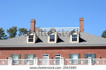 Widows walk on top of office building against blue sky