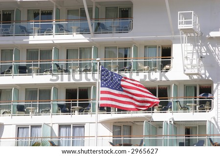 Cruise ship in port with American Flag in foreground