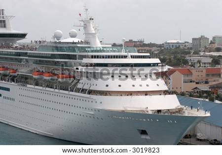 A cruise ship full of passengers tied at dock