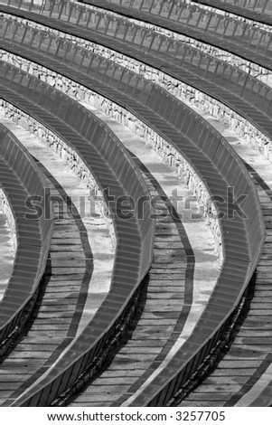 Circular benches in outdoor concert venue in black and white