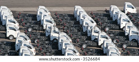 Rows of identical trucks lined up on a pier